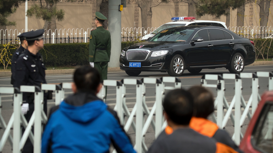 The Latest: Convoy seen in Beijing arriving at train station