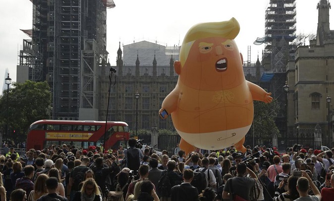 Tens of thousands of protesters greet Trump in U.K. — along with giant baby balloon